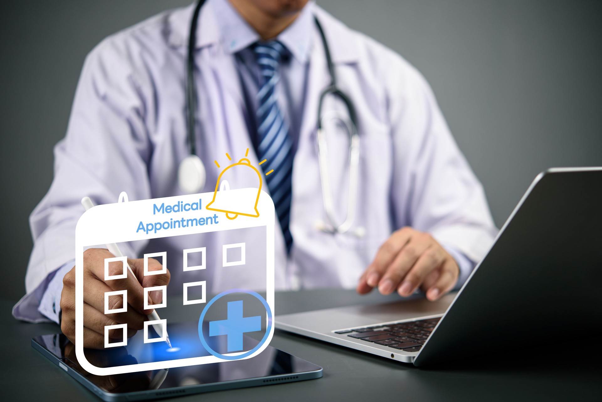 Doctor using digital tablet and laptop with medical appointment calendar icon, online booking system, e-health scheduling, and digital healthcare technology concept.
